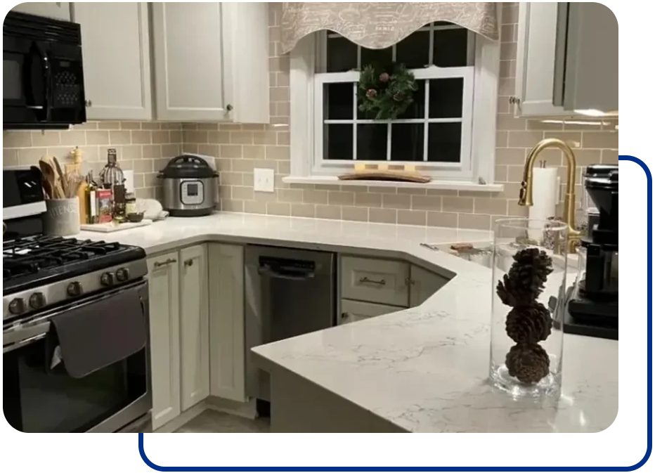 A kitchen with white cabinets and granite counter tops.