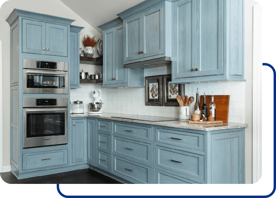 Blue kitchen with cabinets and built-in appliances.
