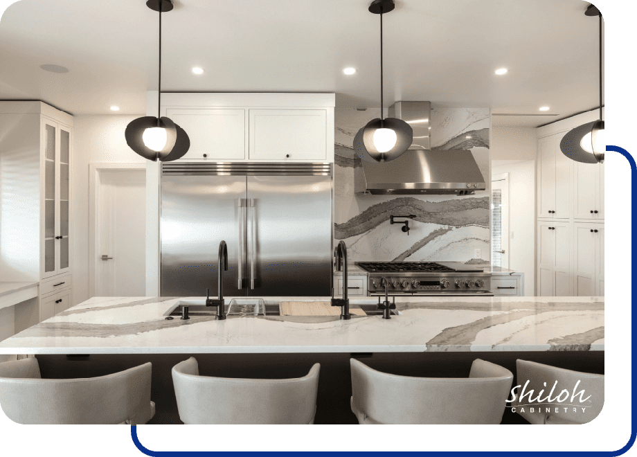 Modern kitchen with marble countertops and lighting.