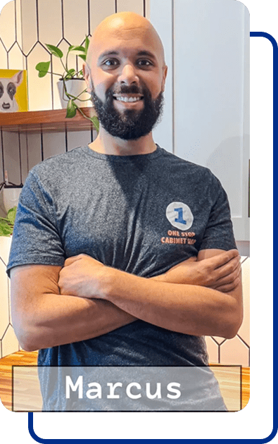 Smiling man standing with arms crossed.